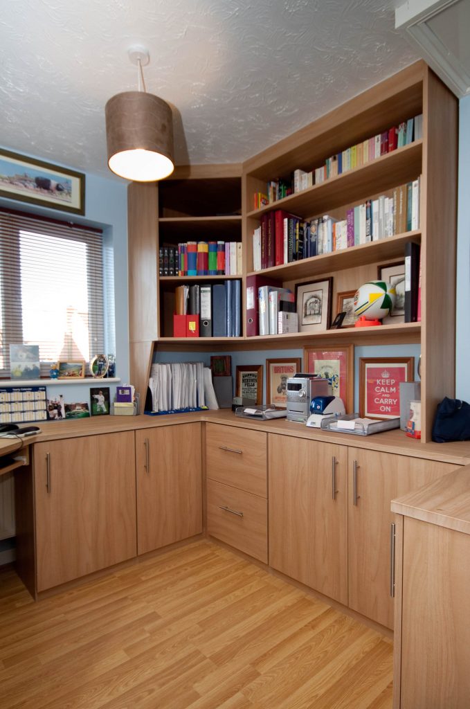 A home office featuring well stocked shelves and cupboards